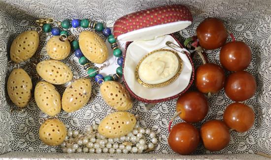 A 9ct gold framed carved ivory brooch, two necklaces and two bracelets.